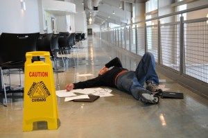 man lies on wet floor